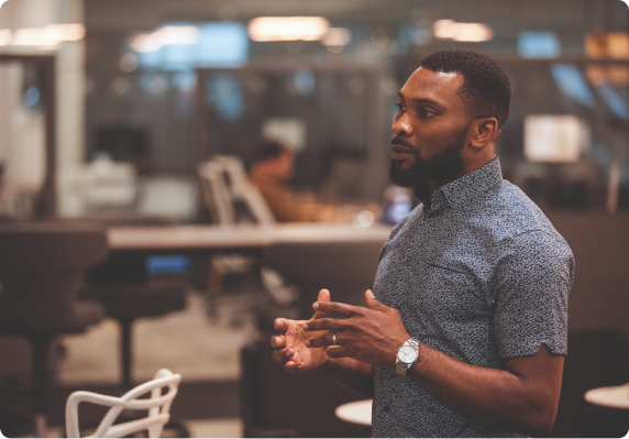 Person speaking in a modern office workspace.