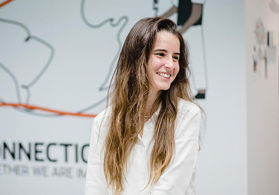 Person with long hair in a bright indoor setting.